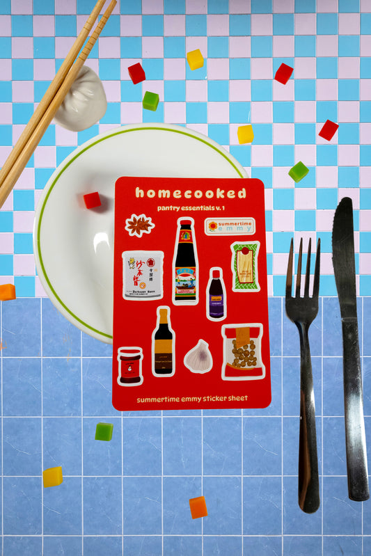 "homecooked: pantry esentials v.1" sticker sheet displayed on plate with table setting