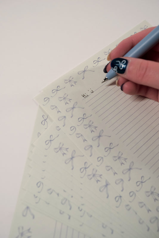 Blue bow stationery with "hi" written on it